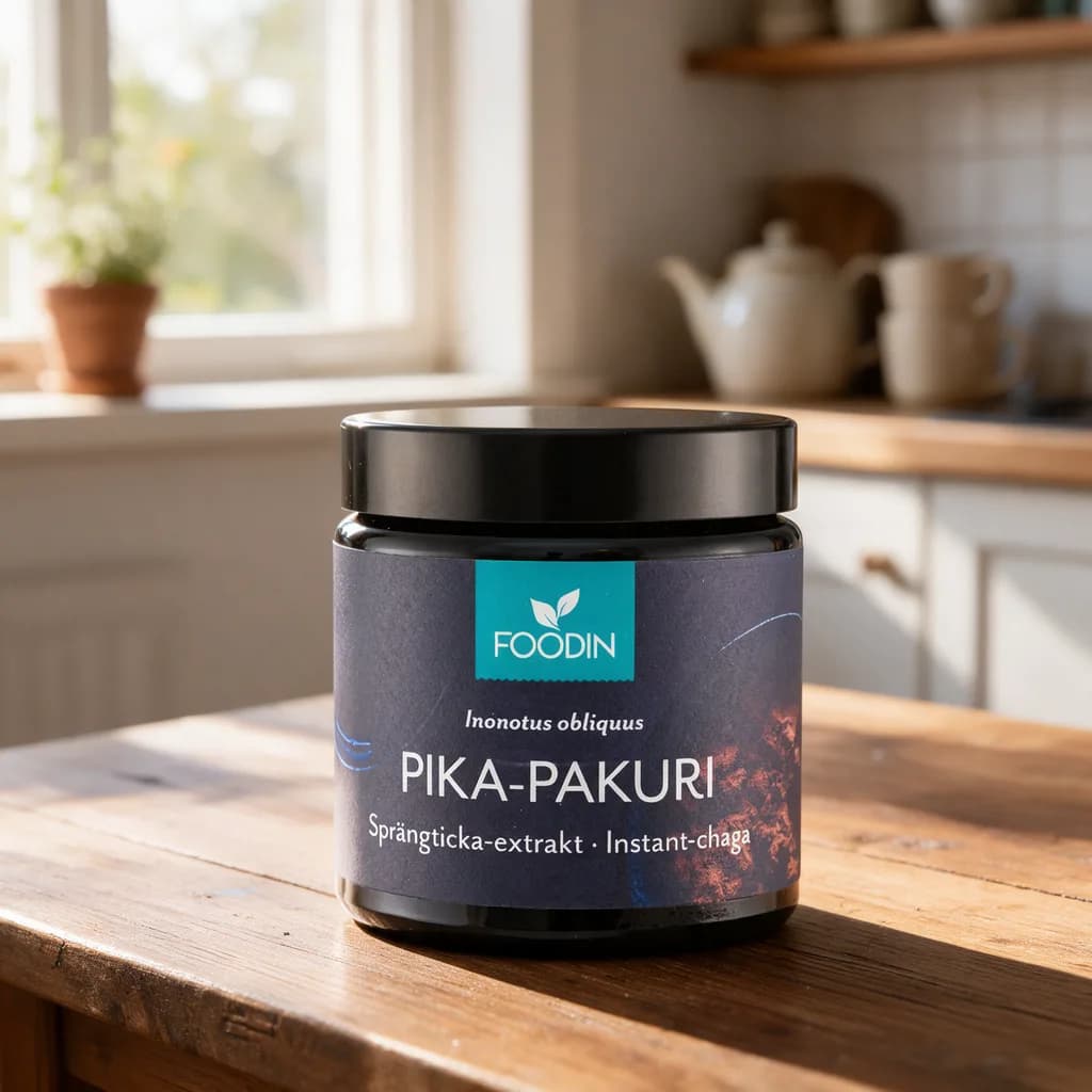 Tummansininen Foodin Pika-Pakuri -lasipurkki puisella keittiön pöydällä