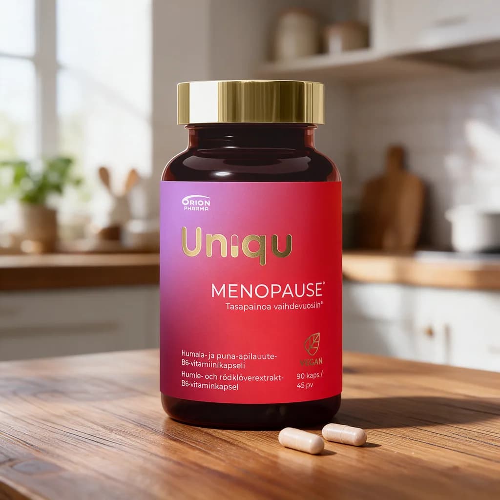 Punaruskea Uniqu Menopause -purkki kullanvärisellä kannella puisella keittiön pöydällä, edessä muutama vaalea kapseli